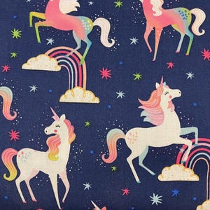 Blue fabric featuring white unicorns, white unicorn, fantasy, whimsical fabric, cotton fabric, stars and rainbows