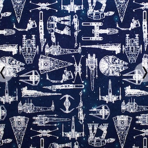 May include: A navy blue fabric with a white outline of various Star Wars spaceships and vehicles. The fabric is covered in a white starry pattern.