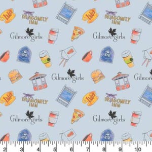 May include: A light blue fabric with a repeating pattern of various images related to the TV show Gilmore Girls. The images include the Dragonfly Inn, Luke's Diner, a pizza slice, coffee cups, and the text "Gilmore Girls".