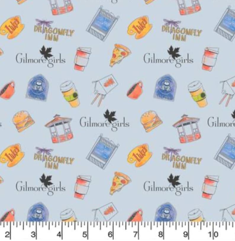 May include: A light blue fabric with a repeating pattern of various images related to the TV show Gilmore Girls. The images include the Dragonfly Inn, Luke's Diner, a pizza slice, coffee cups, and the text "Gilmore Girls".