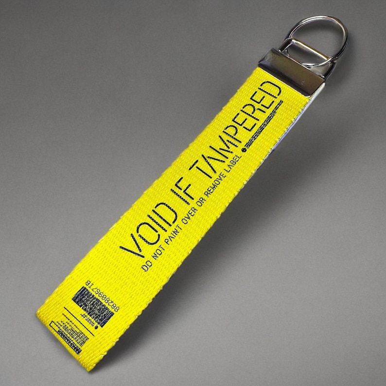 Yellow wristlet keychain for keys  with the words "Void If Tampered"