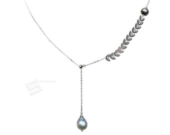 May include: A silver necklace with a delicate chain and a single pearl pendant. The necklace features a silver leaf design on one side.