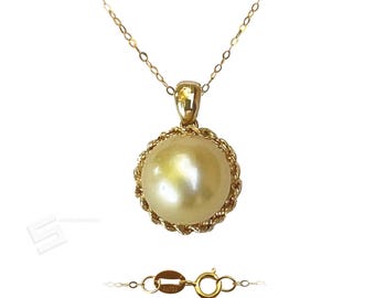 May include: A gold necklace featuring a large, round, cream-colored pearl pendant. The pearl is encircled by a twisted gold rope design. The necklace chain and clasp are also gold. The clasp is marked AU750.