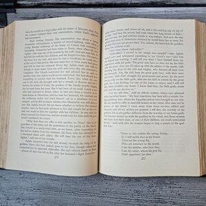 May include: Open book with text on aged paper. The pages display a story about ancient gods and goddesses, with the text and page numbers visible. The book is open, revealing the story's narrative.