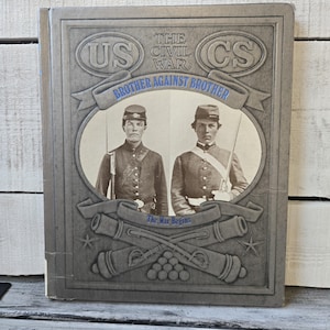 May include: A book cover with the title "The Civil War" and the phrase "Brother Against Brother." The cover features two men in Civil War uniforms, with the letters "US" and "CS" above them. The words "The War Begins" are also present.