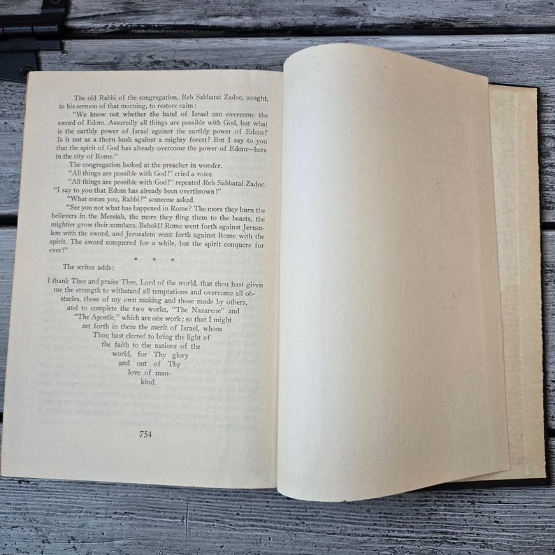 May include: Open book with text on aged paper. The left page features paragraphs of text, while the right page is mostly blank. The text includes phrases like "sword of Edom" and "spirit conquers". The number "754" is at the bottom.
