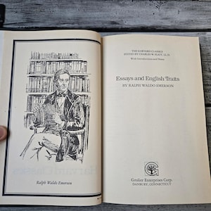 May include: A black and white illustration of Ralph Waldo Emerson, the author of "Essays and English Traits", a book published by Grolier Enterprises Corp. in Danbury, Connecticut.