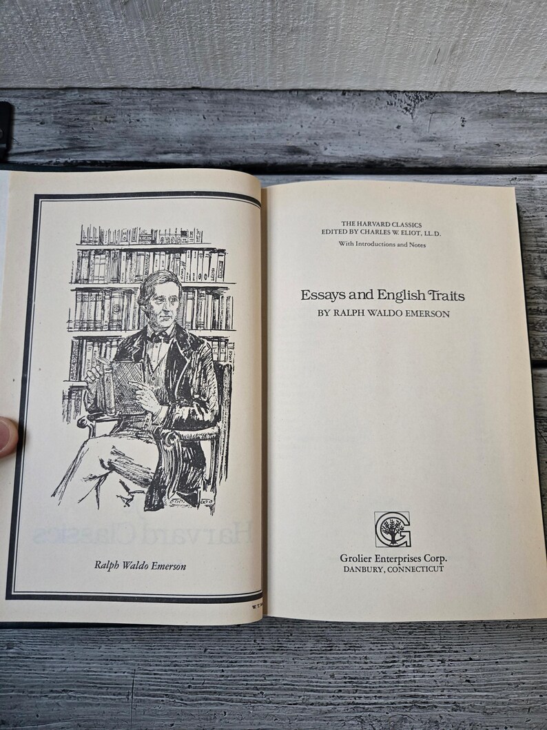 May include: A black and white illustration of Ralph Waldo Emerson, the author of "Essays and English Traits", a book published by Grolier Enterprises Corp. in Danbury, Connecticut.