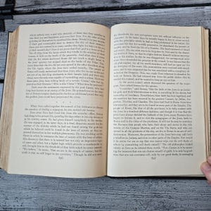May include: An open book with text on aged paper. The pages are yellowed, and the text is in a classic serif font. The book is likely a historical document or a vintage edition. The text is in English. The book is open to page 606.