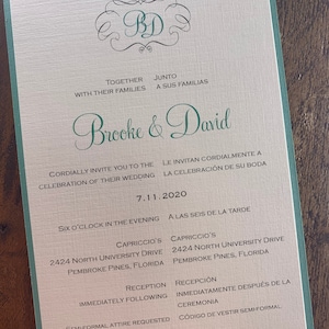 May include: A wedding invitation with a green border and a cream background. The invitation features a monogram of the letters "BD" in a decorative font. The text reads "Brooke & David" in a green cursive font. The invitation details the wedding date, time, location, and dress code.