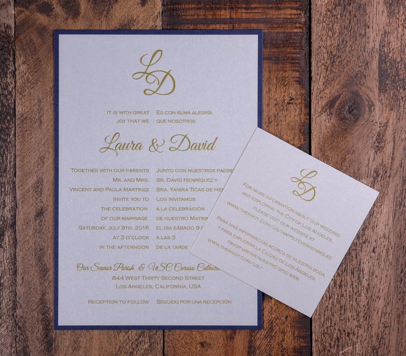 May include: A wedding invitation with a blue border and a gold monogram of the letters "LD". The invitation is for Laura and David and includes the date and time of the wedding ceremony and reception. The text is in both English and Spanish.