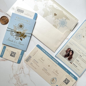 May include: Wedding invitation suite with passport and boarding pass designs. The light blue and cream stationery includes the names "Sarah & Marco" and the date "December 3, 2025." A gold wax seal and map-themed envelope complete the travel theme.