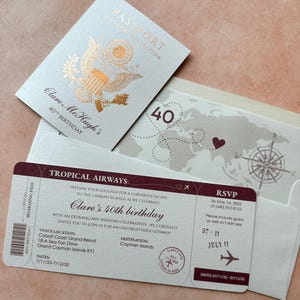 May include: A birthday invitation set featuring a passport-style card with gold foil eagle emblem, a boarding pass for Tropical Airways with maroon text, and an envelope with a world map, compass, and heart-shaped flight path graphic.