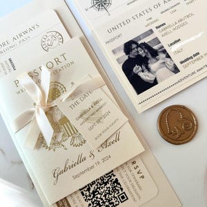 May include: A wedding invitation in the form of a passport with a gold seal and a ribbon. The invitation features a photo of the couple, the date of the wedding, and the location. The text on the invitation reads "Gabriella & Axell, September 19, 2024, Italy".