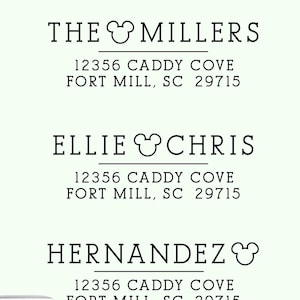May include: A set of four black ink address stamp designs on a light green background. Each design features a name, a street address in Fort Mill, SC 29715, and a mouse-shaped icon replacing the letter O. Includes a self-inking stamp and a wooden handle.