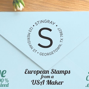 May include: A light blue envelope with a circular stamp featuring the name STINGRAY, address, and a large letter "S". The text "European Stamps from a USA Maker" is also visible.