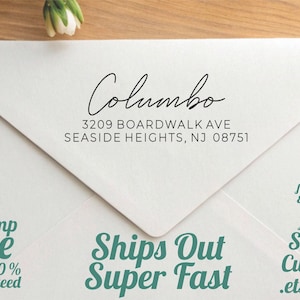 May include: A white envelope with the name "Columbo" in cursive script, along with an address. The envelope also features the text "Stamp Love 100% Guaranteed" and "Ships Out Super Fast". Additional text includes "USA maker featuring European form & function" and "Stamp Customs .etsy.com".