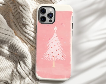 May include: A pink and white phone case featuring a Christmas tree design. The tree has a star on top and red dot ornaments. The case has a white border and is set against a neutral background.