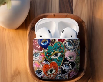 May include: A colorful phone case with a design of hearts and eyes. The case is made of a hard plastic material and has a glossy finish. The case is designed to fit an Apple AirPods Pro case.