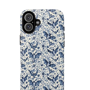 May include: A white phone case with a blue and white pattern of bats and flowers. The case has a cutout for the camera lens.