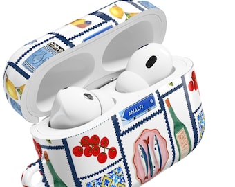 May include: White AirPod case with a colorful Italian-themed design. The case features illustrations of lemons, tomatoes, fish, and wine bottles. The text "AMALFI 9" is visible on a blue sign. The case is open, revealing white earbuds.