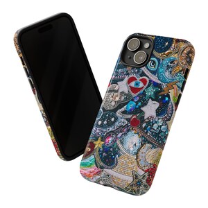 May include: A black phone case with a colourful, glittery design featuring stars, hearts, and other shapes. The case has a cutout for the camera lens.