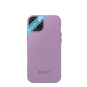 May include: A lavender leather phone case with a textured finish. The case has a raised camera bump and the word "RILEY" is embossed on the back.