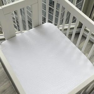 Organic muslin cotton fitted sheets for Nestig Wave, Cloud, Snow, Palm, and Full Cribs.