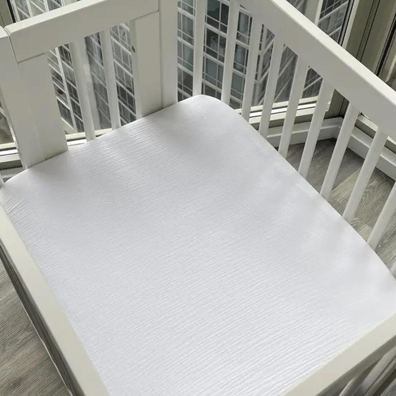 Organic muslin cotton fitted sheets for Nestig Wave, Cloud, Snow, Palm, and Full Cribs.