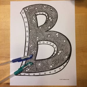 May include: A black and white printable coloring page featuring the letter B with a dotted pattern. The letter is outlined in black and has a thick border.