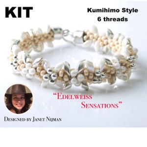 May include: A kit for making a beaded bracelet in a Kumihimo style with 6 threads. The bracelet features white and beige beads with silver accents. The bracelet is called "Edelweiss Sensations" and is designed by Janet Nijman.