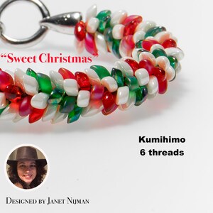 May include: A red, white, and green beaded bracelet with a silver clasp. The bracelet is made using the kumihimo technique with 6 threads. The text "Sweet Christmas" is written on the image.