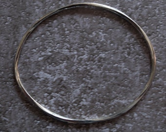 Silver twisted bangle with polished finish