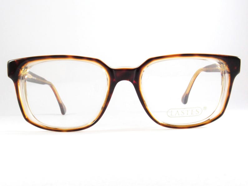 May include: Rectangular eyeglasses with a tortoiseshell pattern on the frames. The lenses are clear, and the temples are a light brown color. The glasses have a vintage aesthetic and are set against a white background.
