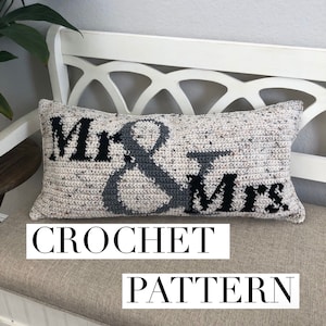 May include: Crochet pattern for a pillow with the words "Mr. & Mrs." in black and gray on a white background.
