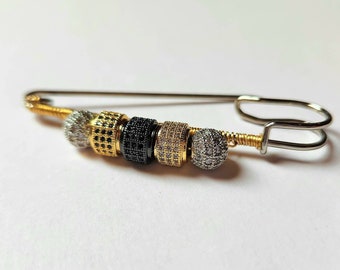 Gold wrapped woth silver, gold and black beads