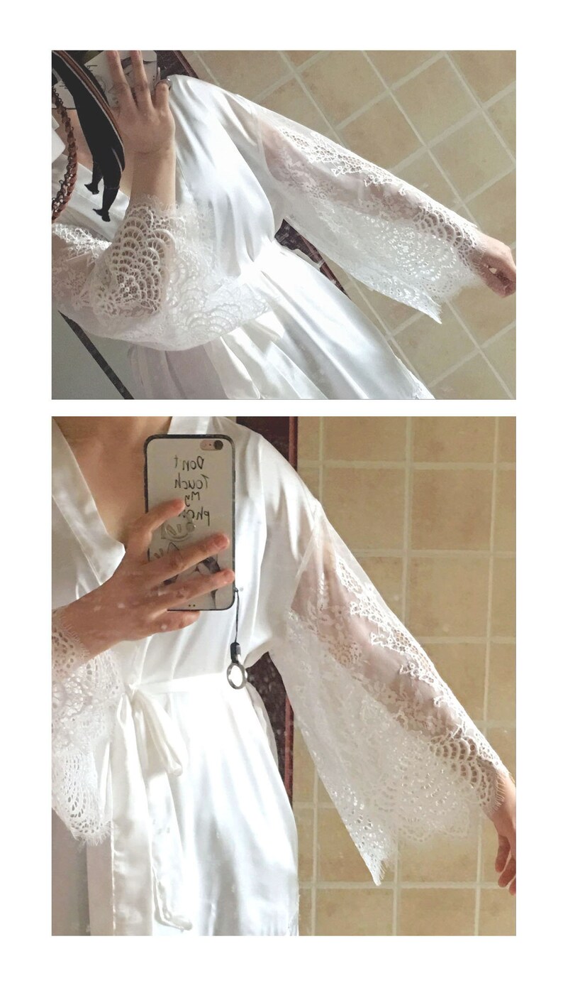 May include: White satin robe with lace trim on the sleeves. The robe has a tie belt and is shown being worn by a person.