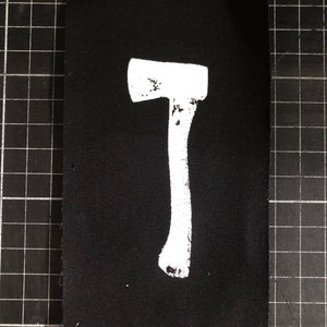 Handgjord yxlapp – screentryckdesign med hög kontrast