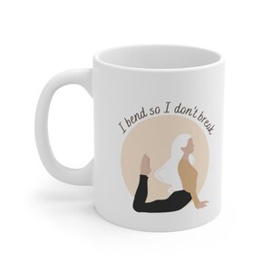 May include: White ceramic mug with a black and brown illustration of a person in a yoga pose. The text "I bend so I don't break" is printed on the mug.