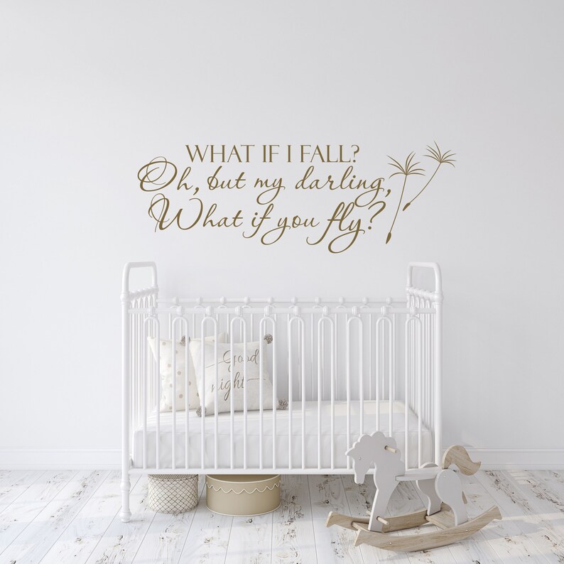 May include: White crib with a white rocking horse in front of it. The wall behind the crib has a brown vinyl decal with the text "WHAT IF I FALL? Oh, but my darling, What if you fly?"