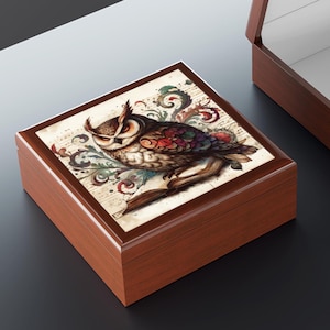 May include: A wooden jewellery box featuring an owl illustration on the lid. The owl is depicted on a book, with floral and musical note designs. The box has a rich, brown finish.