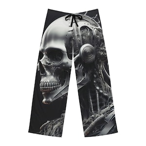 May include: Black and white pajama pants featuring a detailed illustration of a metallic skull and robotic components. The design includes a drawstring waistband and a dark background, creating a striking contrast.