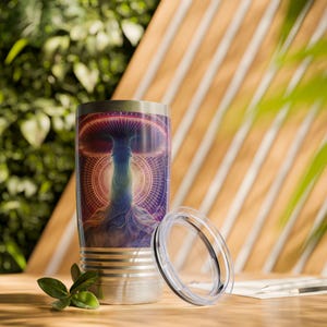 May include: A stainless steel tumbler with a psychedelic mushroom design. The tumbler has a lid and is perfect for keeping drinks hot or cold.