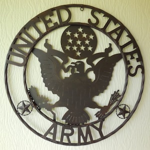 May include: A circular, metal wall hanging with the words "UNITED STATES ARMY" cut out. The design features an eagle with outstretched wings, a circle of stars, and two smaller star accents. The metal has a rustic, brown finish.