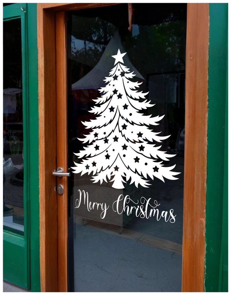 May include: A white vinyl sticker of a Christmas tree with stars on a glass door. The sticker says "Merry Christmas" in a cursive font.