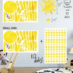 May include: A set of two watercolor sun wall decals. The smaller sun is 1 1/4 inches in diameter and has 10 dots. The larger sun is 21 inches tall and has 112 dots. The decals are yellow and cream.