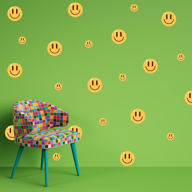 May include: A colourful patchwork chair sits in front of a green wall with many yellow smiley face stickers.