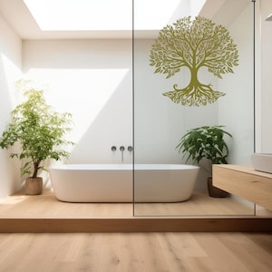 May include: A white bathtub sits on a wooden platform in a bathroom with a glass shower enclosure. A large green tree decal is on the glass shower door.
