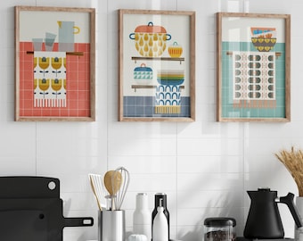 May include: Three framed art prints with a kitchen theme. Each print depicts different kitchen items, such as pots, bowls, and a jug, in a retro, geometric style. The colour scheme includes orange, blue, yellow, and white.