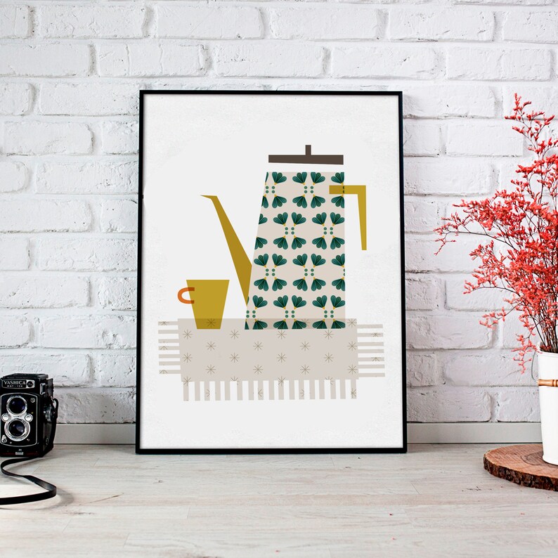 May include: A black framed print of a stylised illustration of a green and white patterned coffee pot with a yellow cup on a beige and white patterned tablecloth.